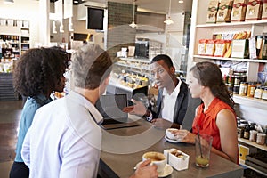 Business Group Having Informal Meeting In Cafe photo