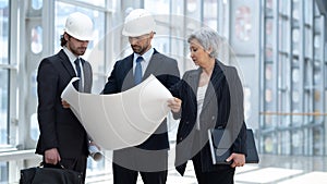 Business group people in builder helmet indoor.