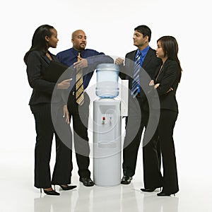 Business group standing around water cooler.