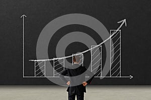 Business growth concept. business man looking to the graph with growth performance and keep goal for success