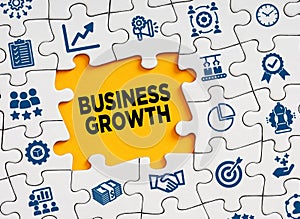 Business growth concept. The word business growth in a missing puzzle piece with business symbols