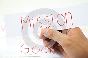 Business hand business mission idea in piece of paper