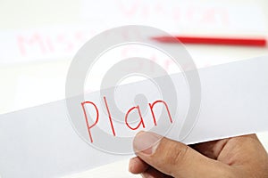 Business hand business plan idea in piece of paper