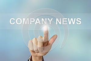 Business hand clicking company news button on blurred background