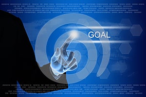 Business hand clicking goal button on touch screen