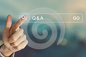 Business hand clicking Q&A or Question and Answer button on sear photo