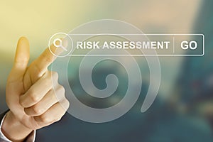 Business hand clicking risk assessment button on search toolbar