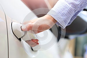 Business hand on handle. Close-up female opening a car door.