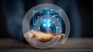 Business hand holding a digital data cube, symbolizing artificial intelligence and secure cloud computing.