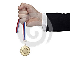 Business hand holding golden medal