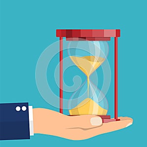Business hand holding a hourglass