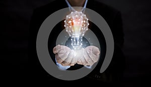 Business hand holding illuminated light bulb, idea, innovation and inspiration concept.concept of creativity with bulbs that shine