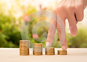 Business hand and money stack gold coin with business investment