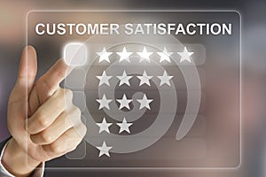 Business hand pushing customer satisfaction on virtual screen