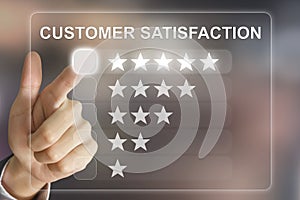 Business hand pushing customer satisfaction on virtual screen photo
