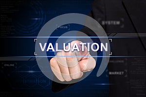 Business hand pushing valuation button on virtual screen