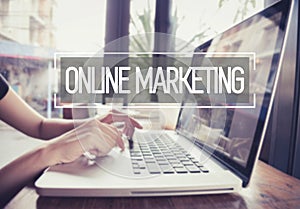 Business hand typing on a laptop keyboard with Online Marketing