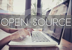 Business hand typing on a laptop keyboard with Open Source