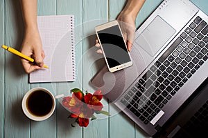 Business hand woman using computer and writing on blank notebook with telephone