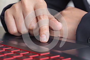 Business hand working on a laptop touchpad