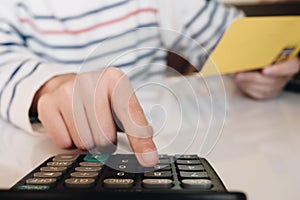 Business hands holding saving account passbook with calculator,