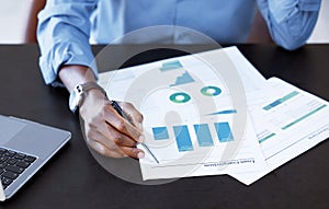 Business, hands and man with documents, graphs and accounting with information, company stats and review profit. Closeup
