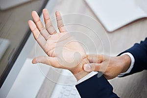 Business hands, pain and wrist on computer from working, discomfort or ache at the office. Employee hand suffering from