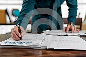 Business hands pointing for checking report chart. Businessman analysing financial report company and calculate profit with report