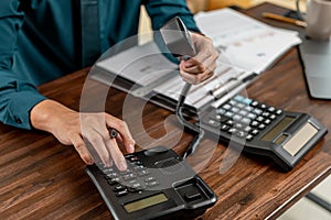 Business hands using telephone in office. Businessman dialing VoIP phone in the office