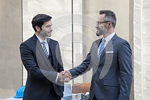 Business Handshake Agreement Partnership. Business people shaking hands and finishing up a meeting. businessman and attractive