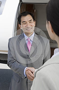 Business Handshake At Airfield