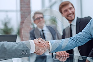 Business handshake on the background of applauding business team