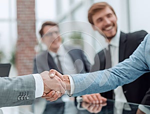 Business handshake on the background of applauding business team