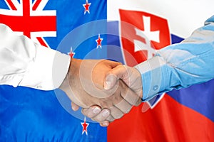 Handshake on New Zealand and Slovakia flag background