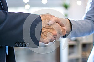 Business handshake on bright background.