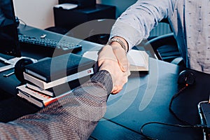 Business handshake. Business handshake and business people concept. Two men shaking hands over sunny office background.