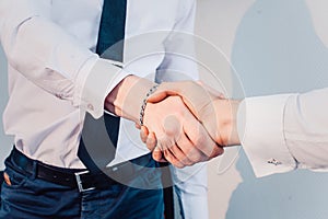 Business handshake. Business handshake and business people concept. Two men shaking hands over sunny office background.