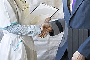 Business handshake. Businessman shaking hands with doctor shaking hands.