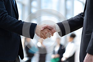 Business handshake close-up on a office background.