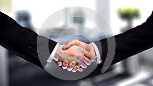 Business handshake on company office background, partnership trust, respect sign