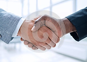 Business handshake in lofty office