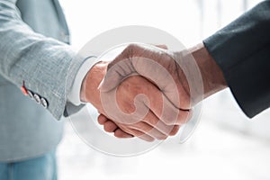 Business handshake in lofty office