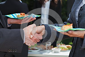 Business handshake during lunch