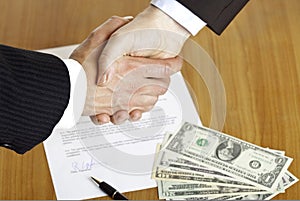 Business handshake after signed contract