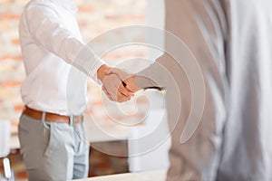 Business handshake. Two businessman shaking hands with each other outside