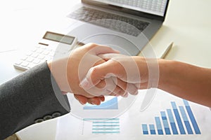 Business handshake. Two businessmen reaching an agreement and making a deal