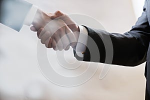 Business handshake of two businessmen in suits, negotiate and make a deal