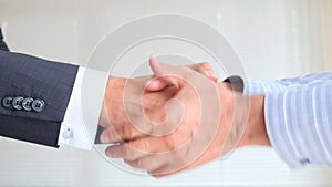 A business handshake. Two men shake hands. 4k, slow-motion