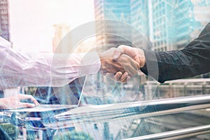 Business handshake on urban outdoor building background