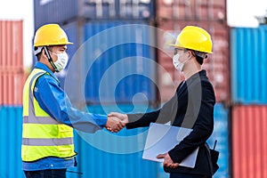 Business handske with Supervisor control loading Containers box from Cargo freight ship for import export